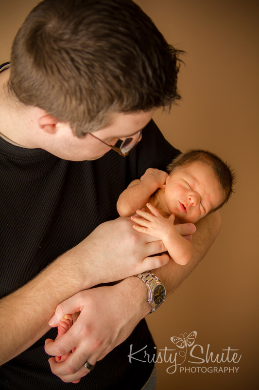 Kitchener Newborn Photography Kristy Shute Dad holding Baby Boy Sleeping 