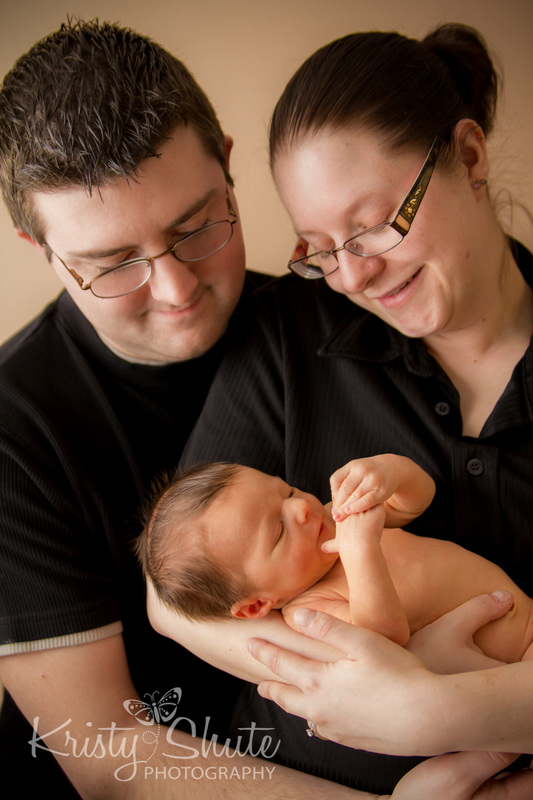 Kitchener Newborn Photography Kristy Shute Mom and Dad holding Baby Boy 